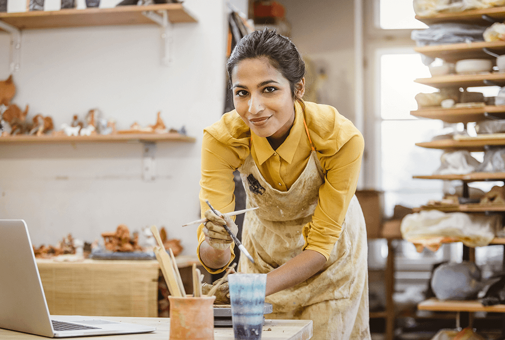 Women holding painting utensils.